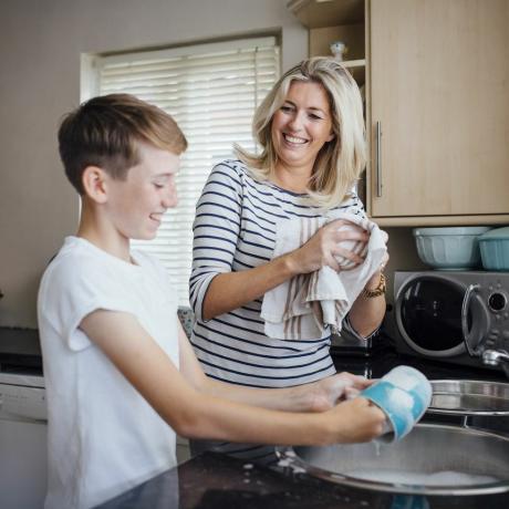 moeder en zoon doen de afwas